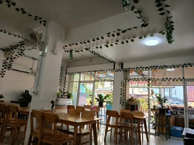 The bright, plant-filled dining room of Tess Vegan Cafe
