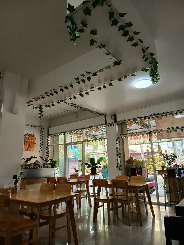 Lush tropical plants inside Tess Vegan Cafe