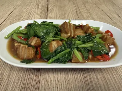 Stir-fried kale with plant-based crispy pork.